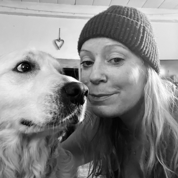 Amy with her dog in a relaxed, outdoor setting